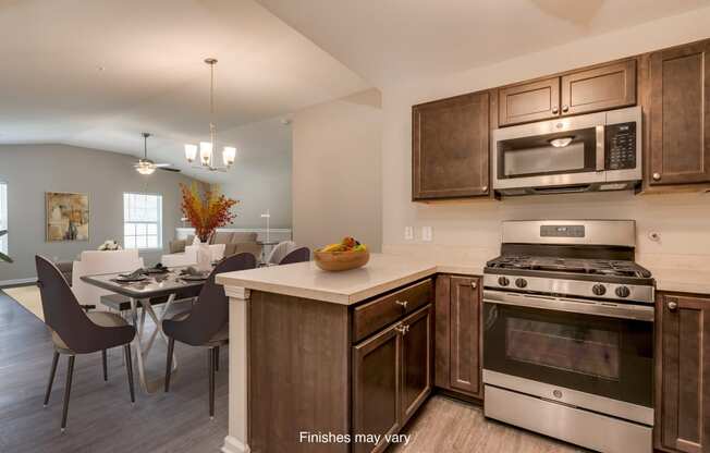 a kitchen and dining room with stainless steel appliances and wooden cabinets