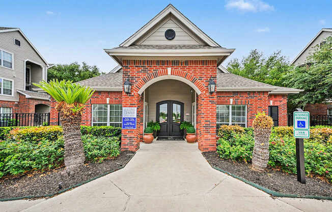 A brick building with a sign that says "Welcome to Veterans Village.".