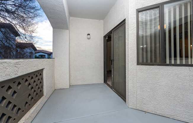 A white house with a grey door and a window.