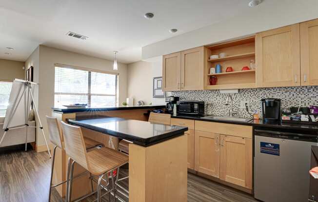 a kitchen with wooden cabinets and a black counter top