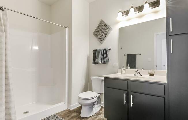 a bathroom with a toilet sink and shower