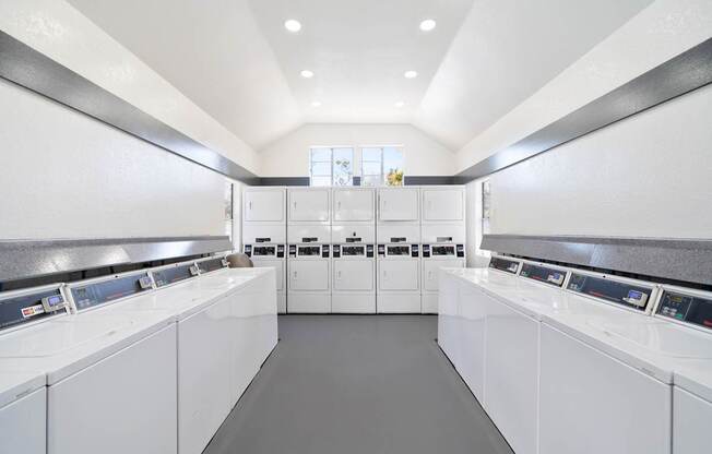 A laundromat with rows of washers and dryers.