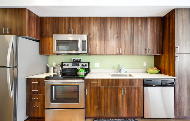 a kitchen with stainless steel appliances and wooden cabinets