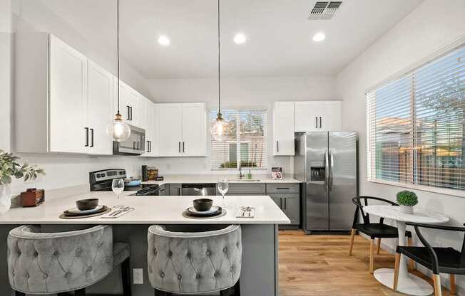 A modern kitchen with a dining table and chairs.