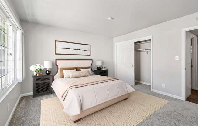 A bedroom with a large bed and a window.