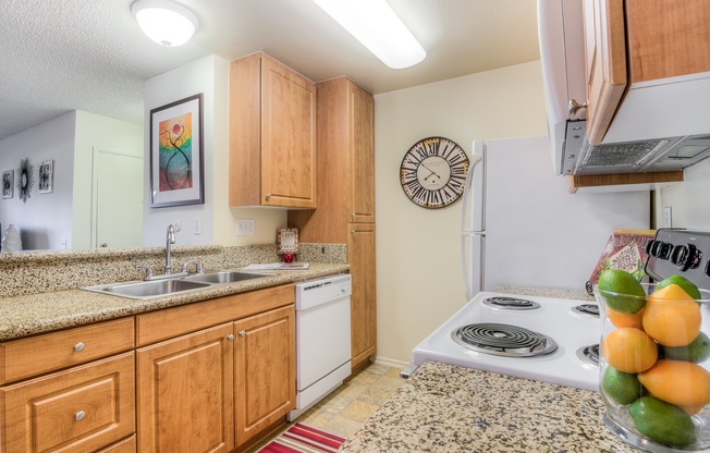 A kitchen with wooden cabinets and a white stove top oven.