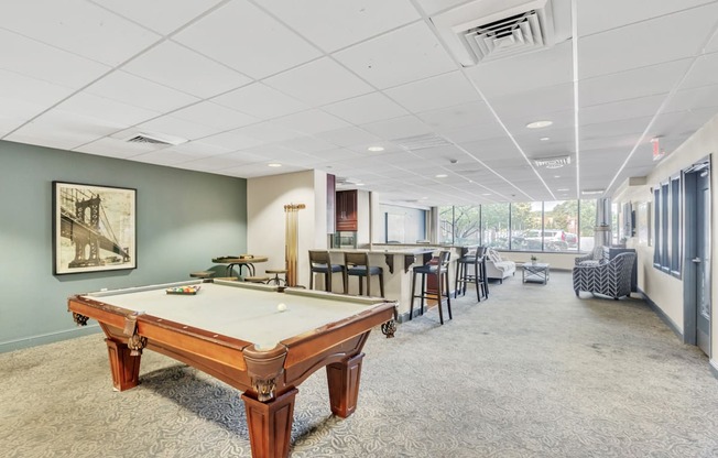 a game room with a pool table and a bar