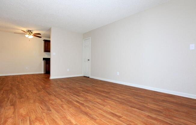 a large empty room with a hard wood floor