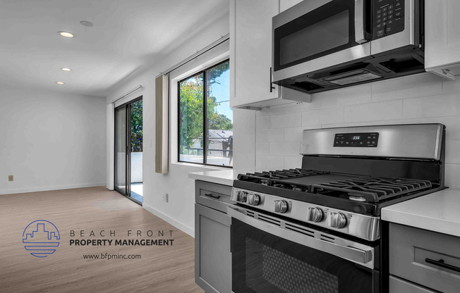 a kitchen with a stove top oven next to a window