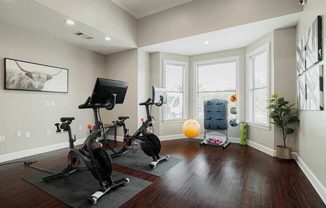 A room with a wooden floor and exercise equipment.