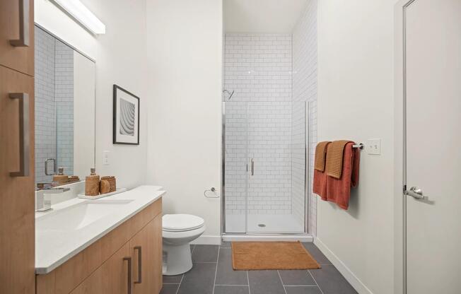 Frameless glass showers with floor-to-ceiling tile surrounds are available in select apartments.