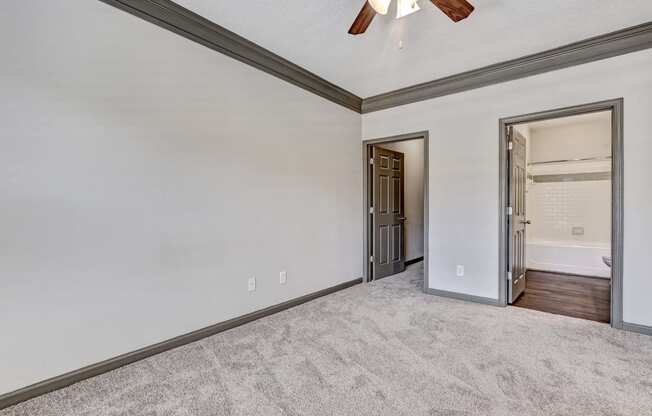 Carpeted Bedroom With Ceiling Fan & Light