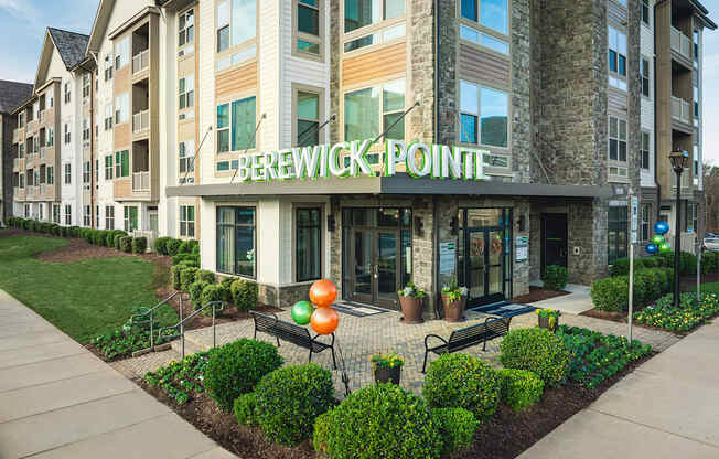 The front of the Brewick Pointe apartment building with a landscaped area in front.