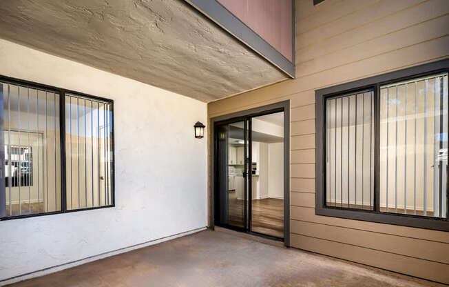 A modern house with a glass door and a black window.