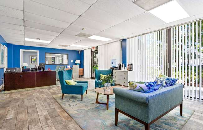 a lobby with couches and chairs and a reception desk