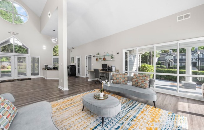 a living room with a gray couch and a yellow rug