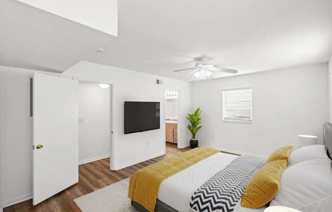 a bedroom with a large bed and a ceiling fan