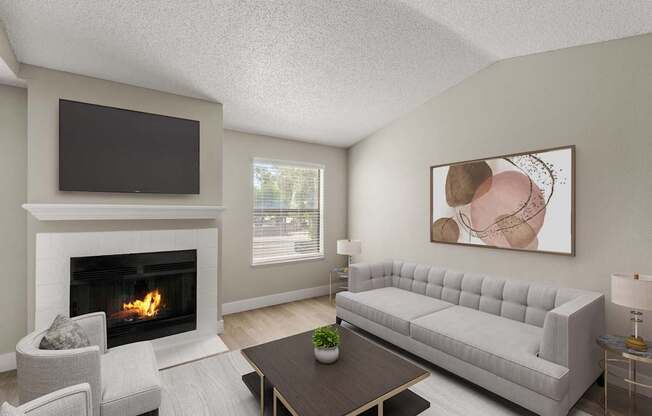 A living room with a fireplace, a grey sofa, a coffee table, and a painting on the wall.