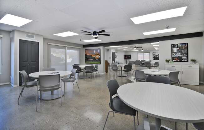 A conference room with a white table and chairs.