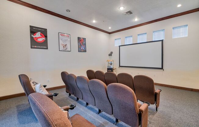 a conference room with chairs and a projector screen on the wall at Club at Coldwater Springs, Avondale, AZ 85323