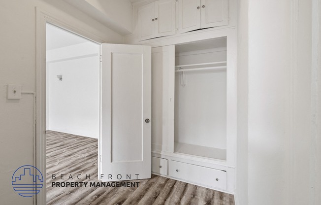 a renovated closet with white cabinets and white doors