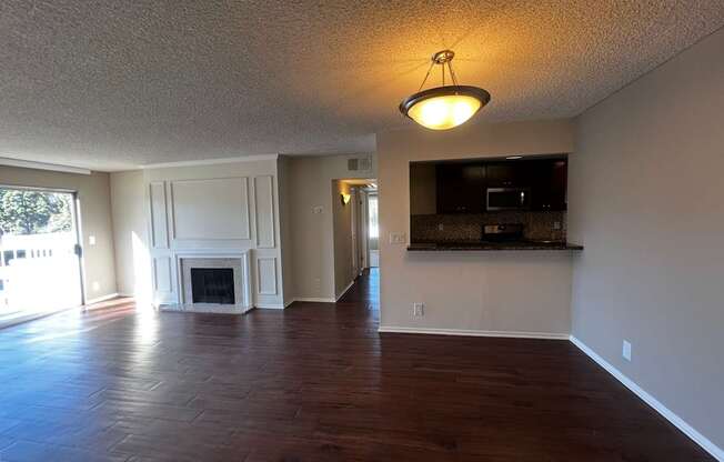 A living room with a fireplace and a television.