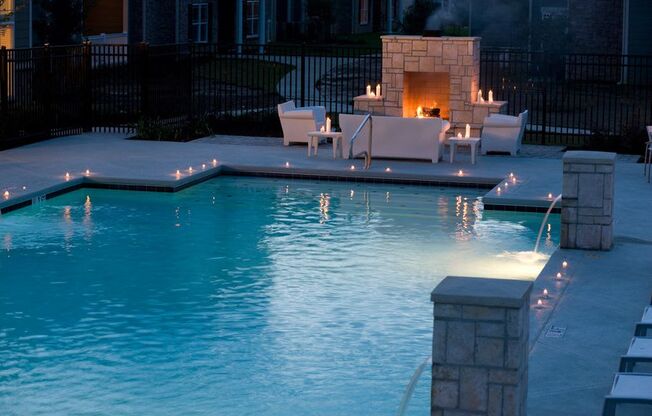 a swimming pool with a fireplace in the background