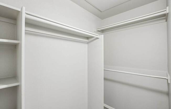 A white closet with shelves and a door.