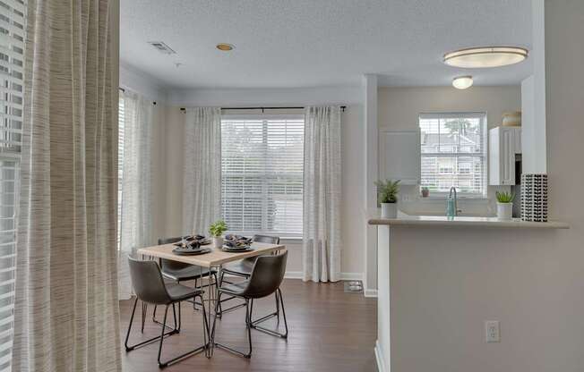 A dining room with a table set for four.