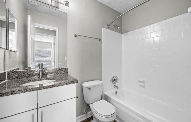 Renovated bathroom with granite top vanity and stylish light fixture.  at Concord Crossing, Georgia, 30082