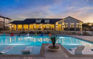 A pool with a building behind it.