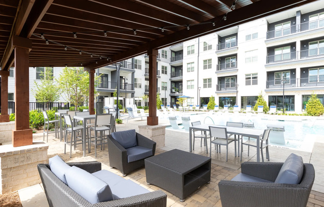 Outdoor lounge at our apartments for rent in Atlanta, GA, featuring outdoor seating and a shade structure.