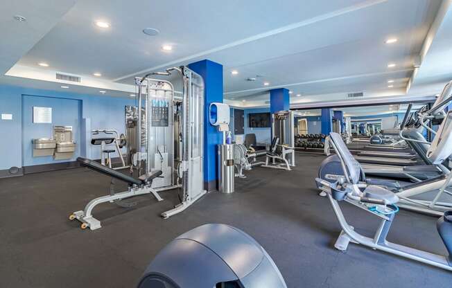 a gym with cardio equipment and weights at the apartments