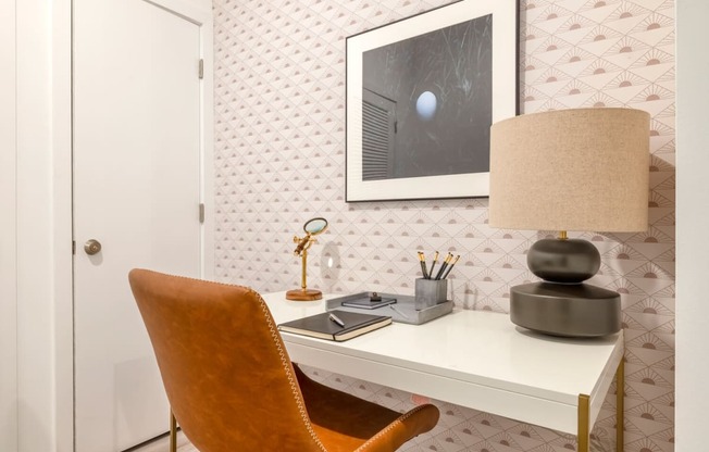 Model room with desk with a lamp and a chair in a room