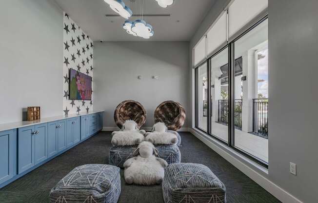 A room with a grey carpet and a white ceiling with lights.