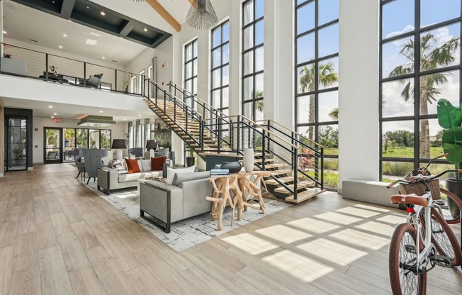 Clubhouse with furniture, stairs to the second floor, and miscellaneous decor