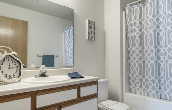 Attached bathroom with cabinet storage space and new flooring at Northridge Heights