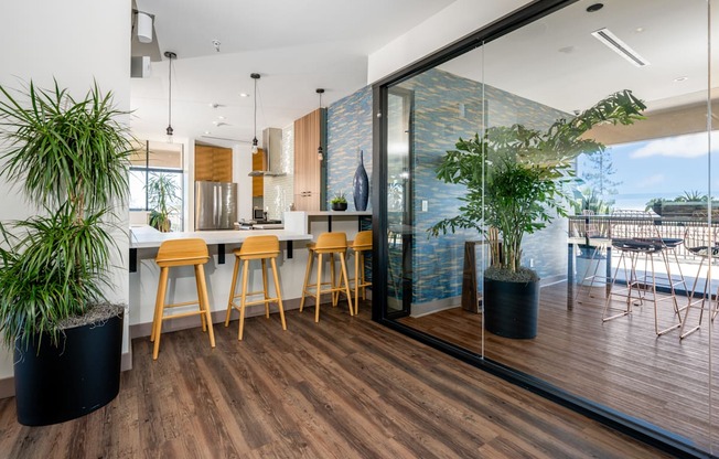 A modern kitchen with wooden floors and furniture.