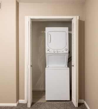 A white washing machine is in a doorway.