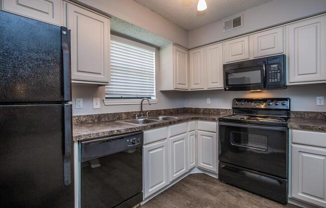 a stove top oven sitting inside of a kitchen