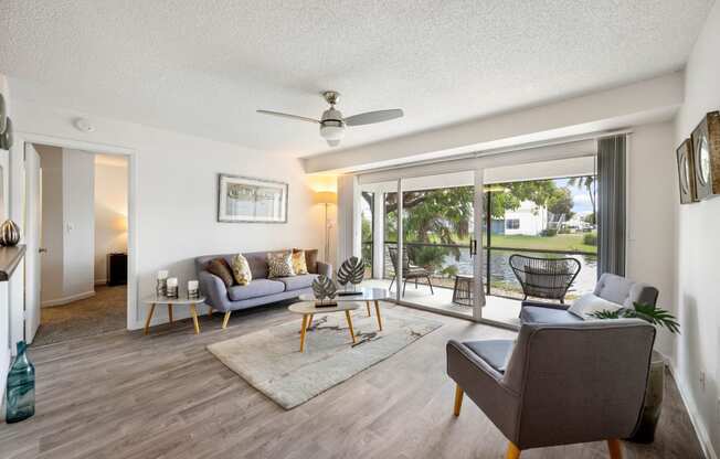 a living room with couches and chairs and sliding glass doors to a patio