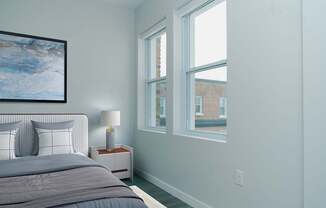 A bedroom with a large bed and a painting on the wall.