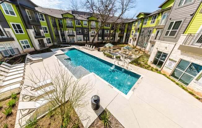 Pool overview with poolside seating, and BBQ area