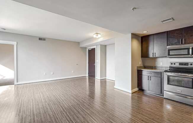 a kitchen with stainless steel appliances and a wooden floor