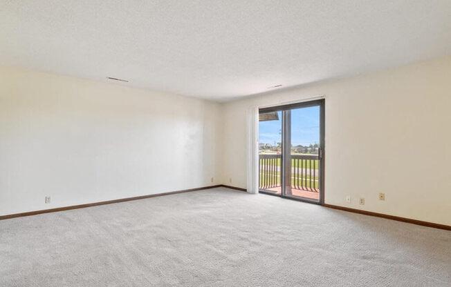 apartment living room with a sliding door to a balcony