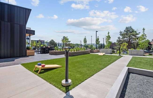 A modern outdoor area with a bench, a pole, and a gravel bed.