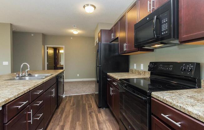 FULLY-EQUIPPED KITCHEN AT THE SUMMIT AT SUNNYBROOK VILLAGE