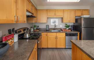 a kitchen with wooden cabinets and stainless steel appliances