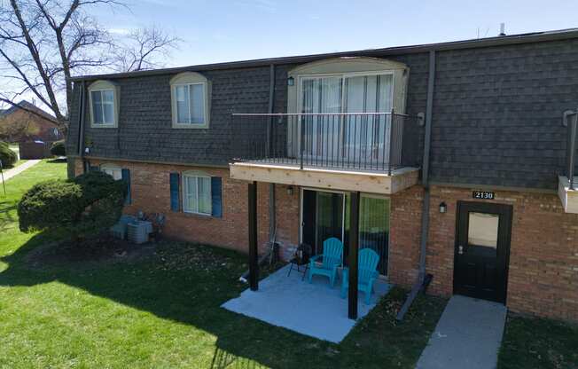 an aerial view of a brick house with a balcony