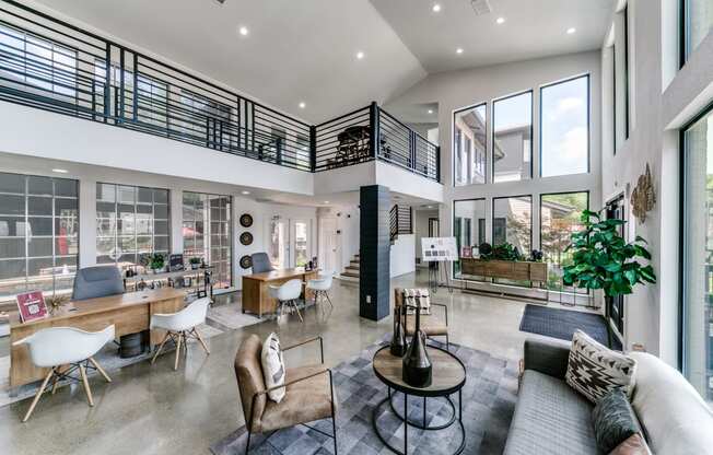a living room with couches and chairs and a large balcony